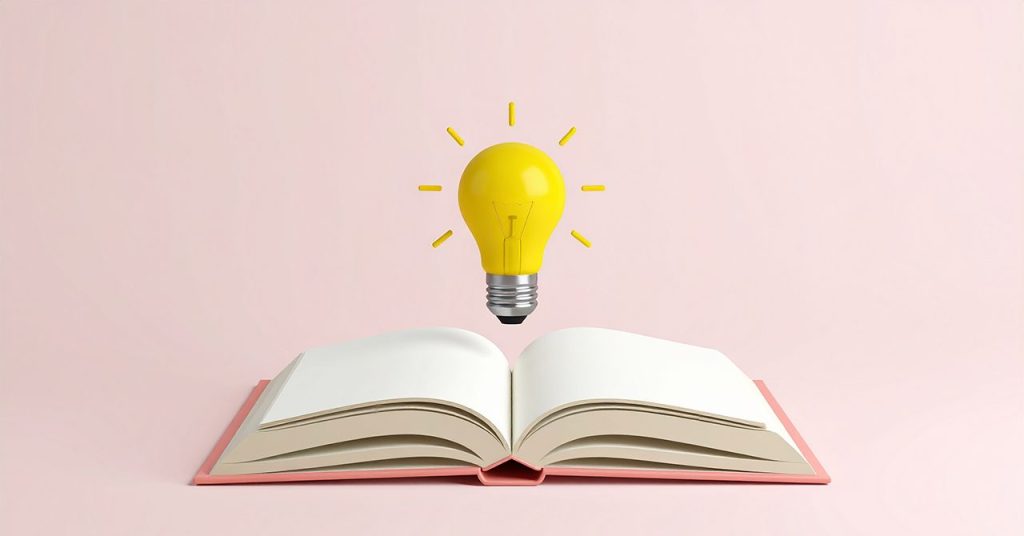 開いた本の上に、ピカッと光る電球が浮いているビジュアル。ひらめき、気づきを想起させる。